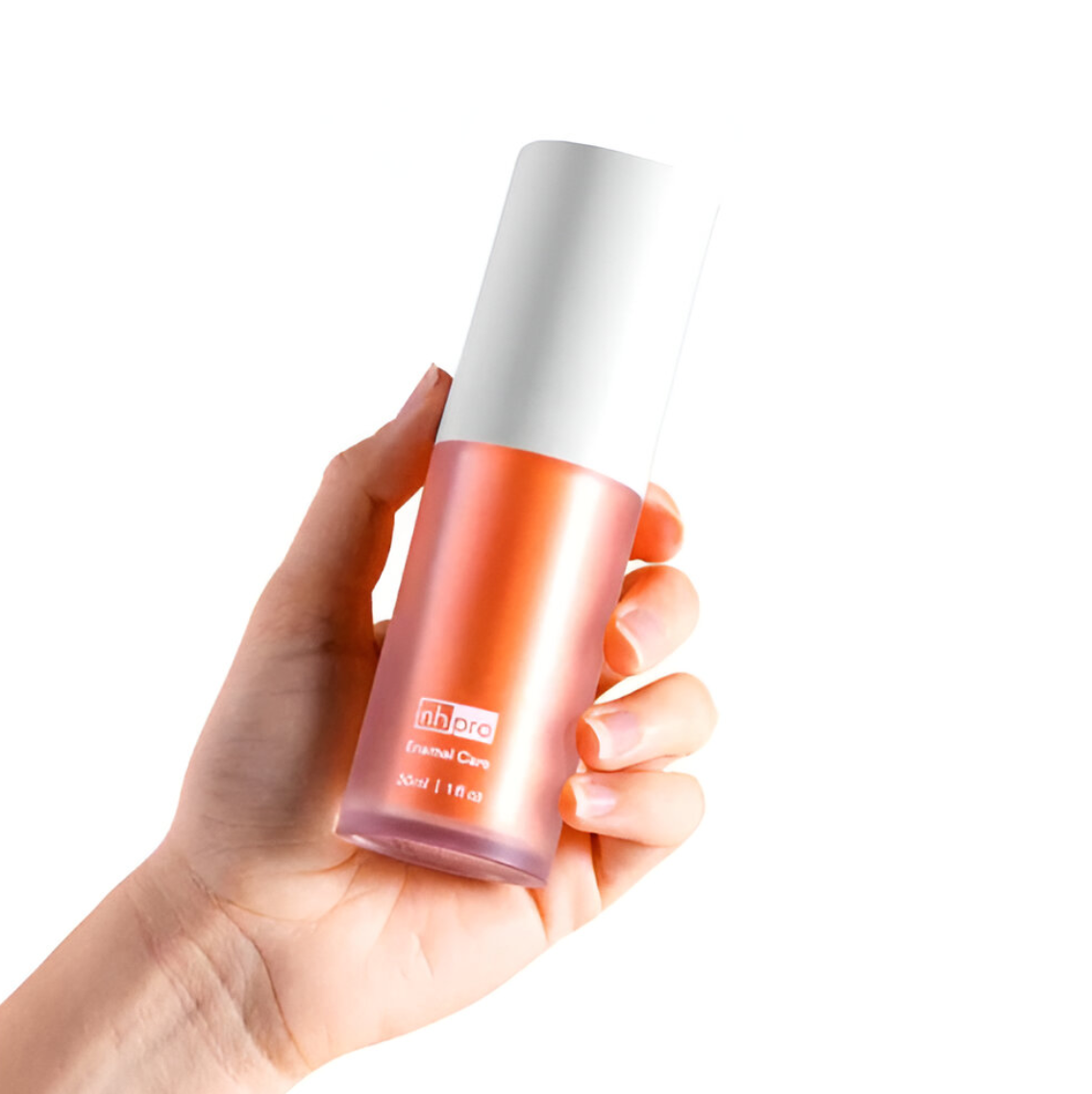 Orange oral care toothpaste being held by a hand 